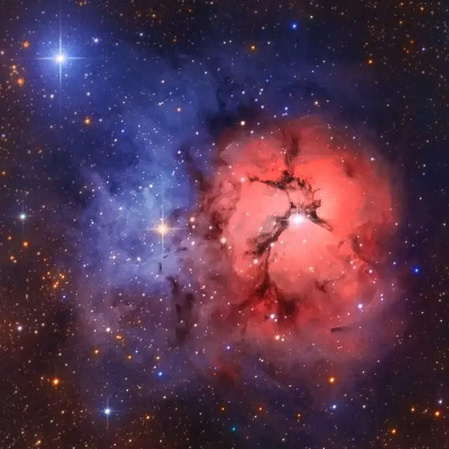 Photograph of Trifid Nebula, a nebula in Sagittarius.