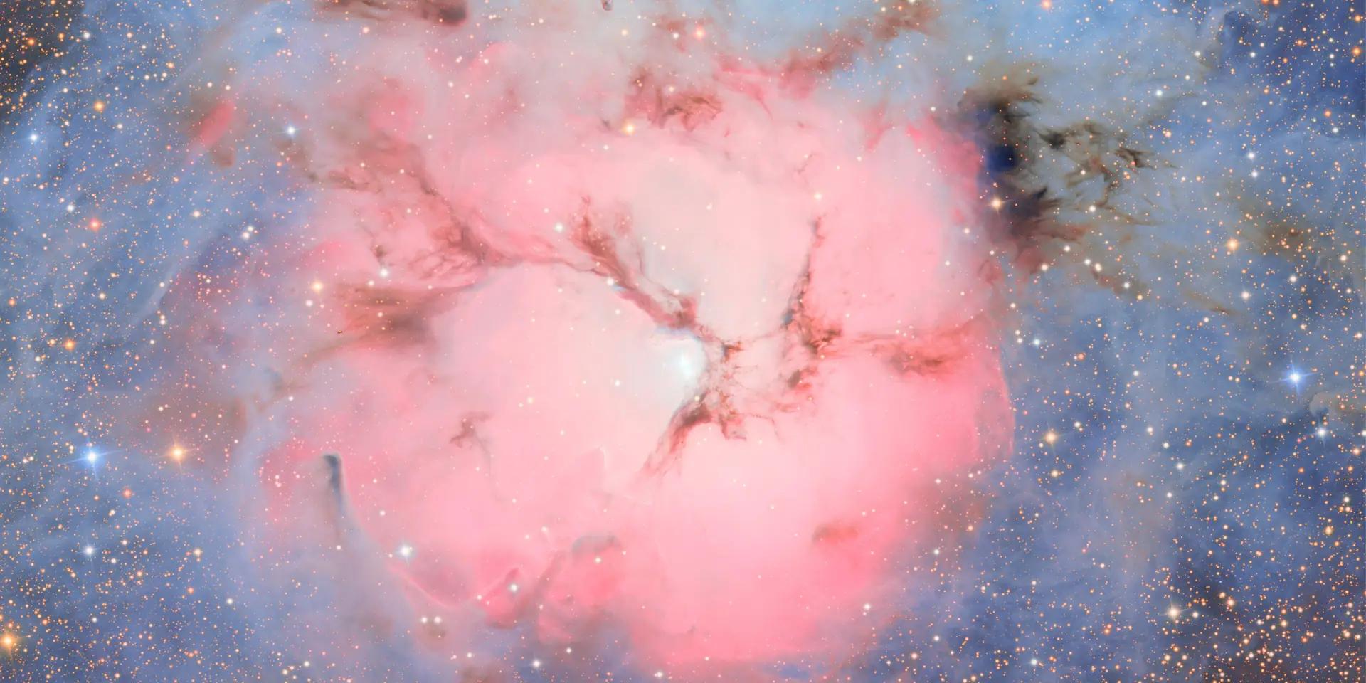 Photograph of Trifid Nebula, a nebula in Sagittarius.