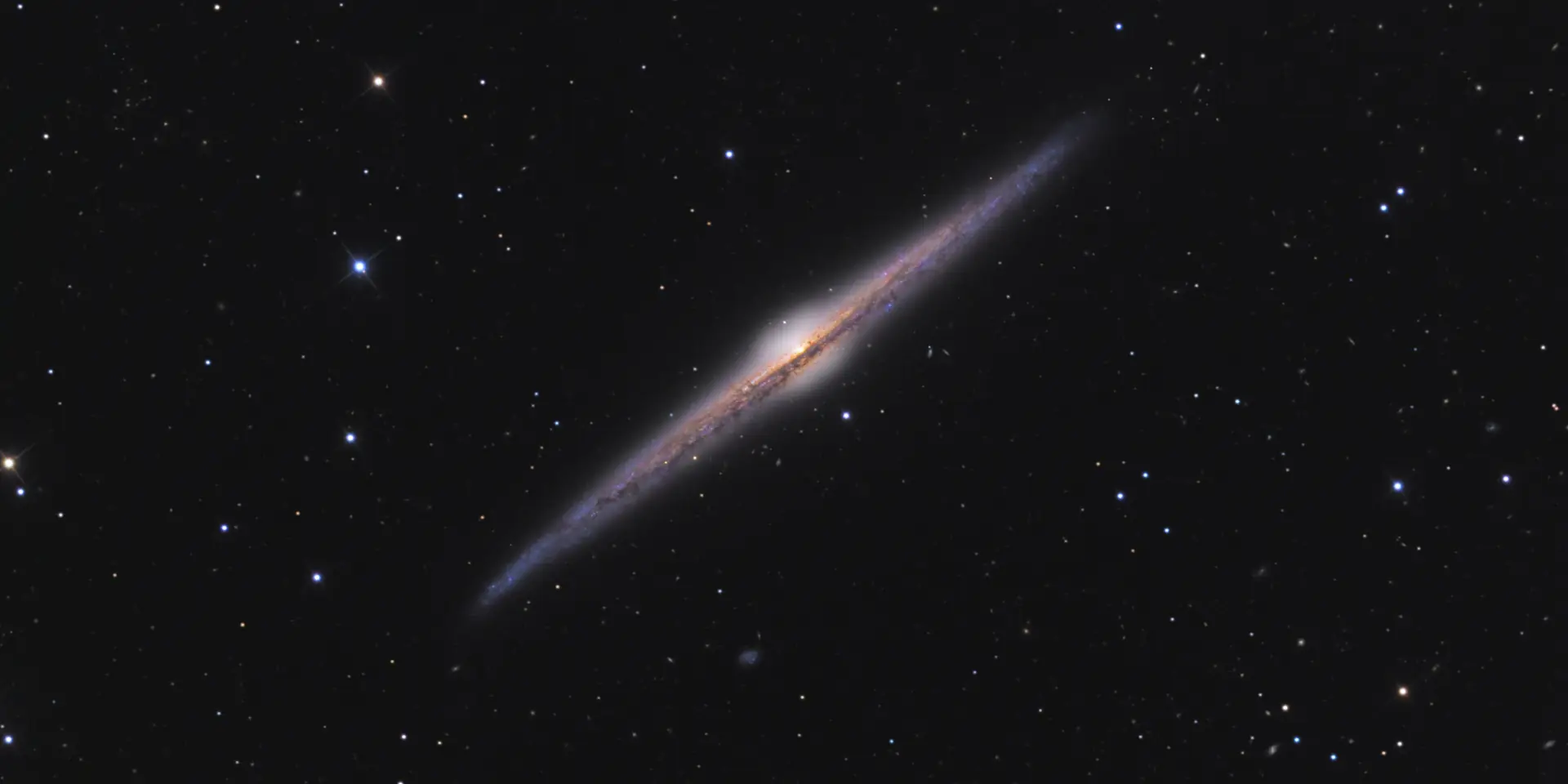Photograph of Needle Galaxy, a spiral galaxy Sb in Coma Berenices.
